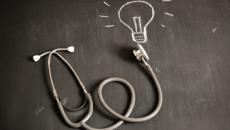 Stethoscope and drawing of lightbulb on chalkboard