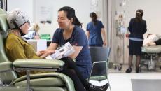 A nurse attending to a patient in the San's Poon Day Infusion Centre