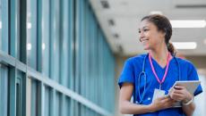 Smiling healthcare worker holding tablet