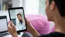 Person talking to doctor on tablet