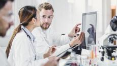 Lab workers looking at a monitor