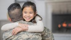 Servicemember hugs child