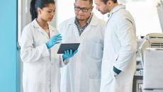 Doctors looking at a tablet 