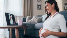 Pregnant person talking to doctor on laptop screen