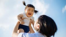 Parent holding child in the air