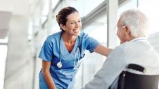 A nurse interacting with a senior patient in a wheelchair