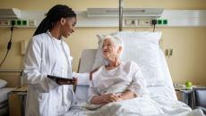 A doctor interacting with a patient in bed