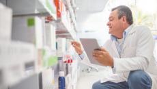 A pharmacist doing an inventory using a digital tablet