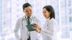 Doctors reviewing data on a digital tablet