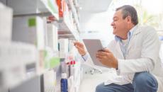 A pharmacist doing an inventory using a digital tablet