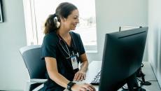 Triage nurse reviews EHR as she registers a patient.