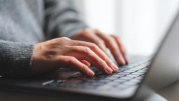 woman's hands on laptop