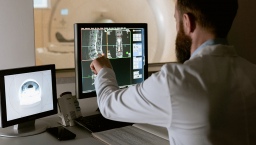 Radiologist looks at an MRI on screen