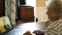 Person speaking to healthcare worker on laptop