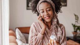 Person on the phone holding pill bottle