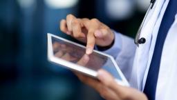 Clinician hands holding tablet