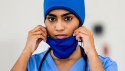 Healthcare worker taking off mask