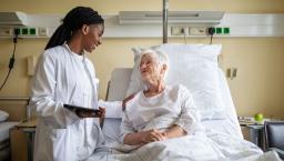 A doctor interacting with a patient in bed