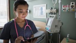 A doctor reviewing a patient's record on a digital tablet