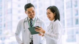 Doctors reviewing data on a digital tablet