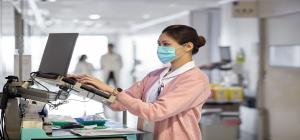 A medical professional using a computer at a hospital.