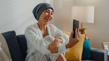 Smiling person looking at a smartphone