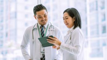 Doctors reviewing data on a digital tablet