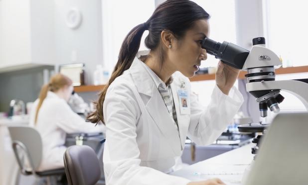 Lab worker using a microscope