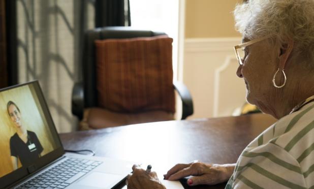 Person speaking to healthcare worker on laptop