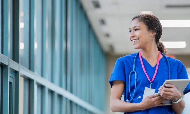 Smiling healthcare worker holding tablet