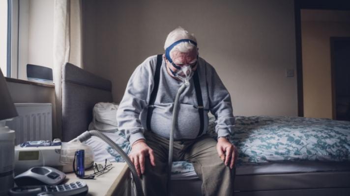 Senior man with oxygen mask.