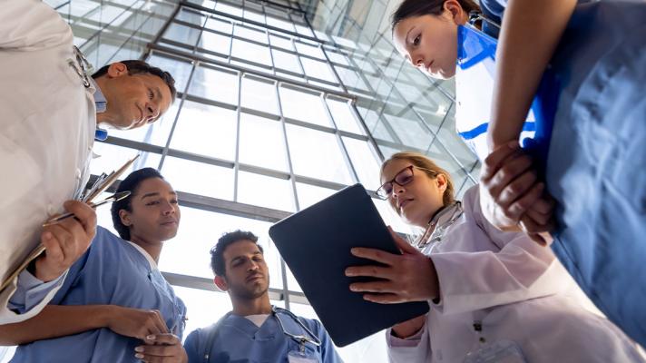 Clinicians reviewing information on a tablet