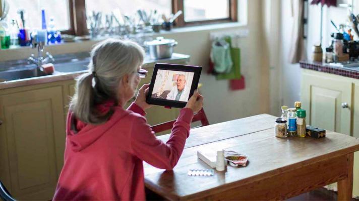 Person talking to a doctor on a tablet screen