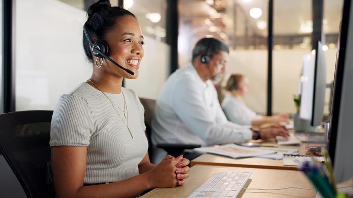 Woman works IT help desk in a support center