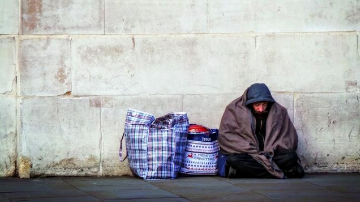 Homeless person sleeping on the street.