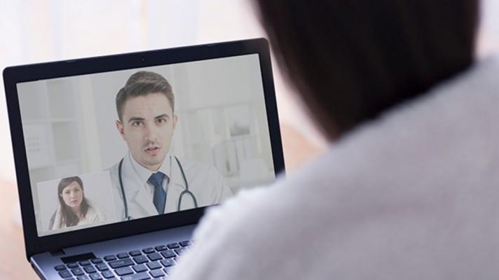 A person talking to a doctor on a computer screeen