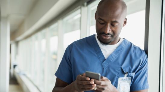 Doctor using mobile device.