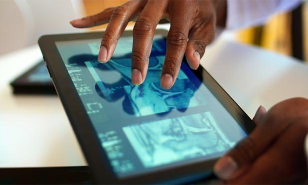 Doctor looking at a medical image on a tablet